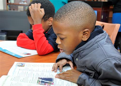 Two elementary school boys reading 